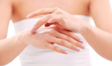 a girl applies ointment to her hand